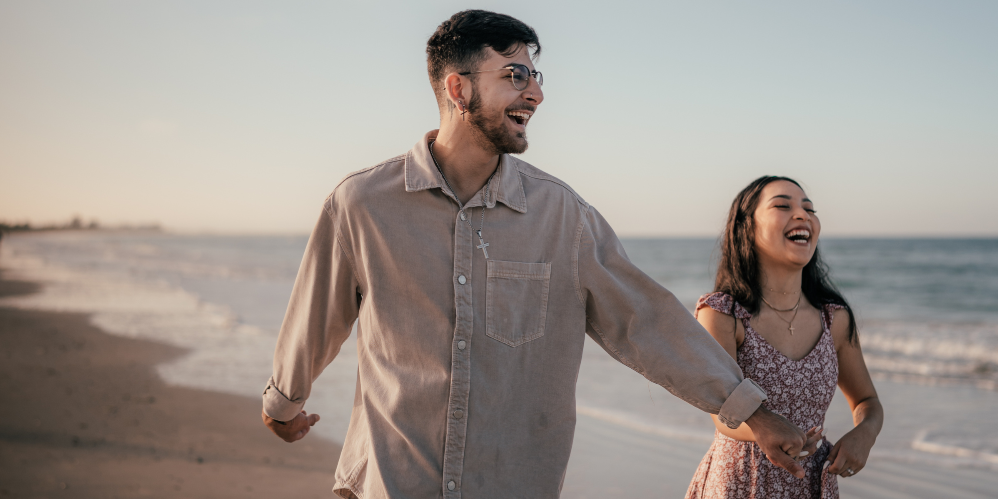 A man in woman running down a beach together. The woman is wondering "How Does Abortion Affect Relationships?"