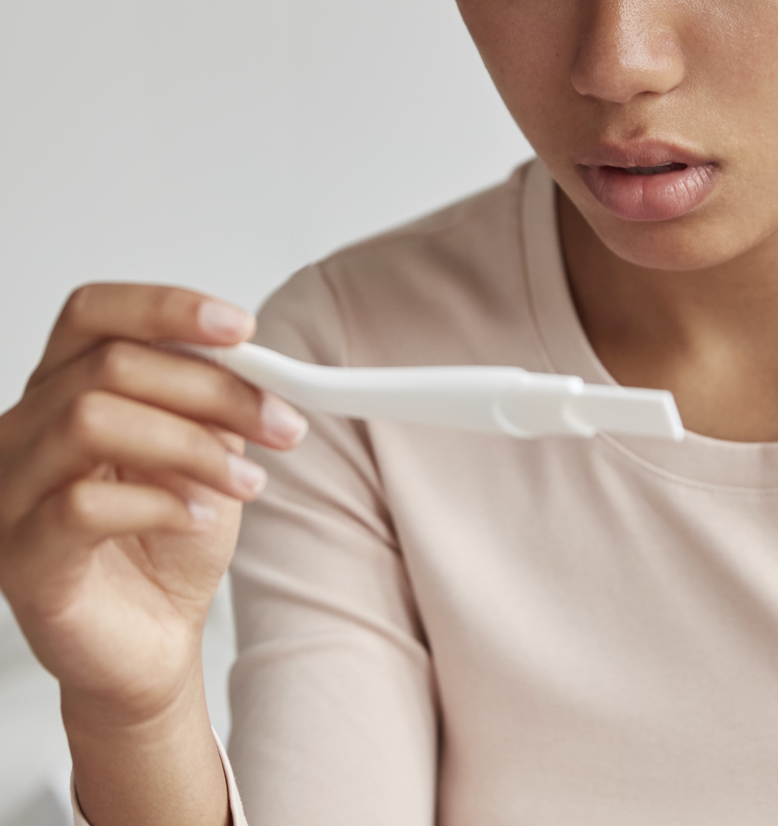 A woman holding a free pregnancy test at Lauren's Legacy Pregnancy Center